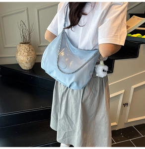Light blue glossy patent leather hobo bag with silver chain detail and monster charm
