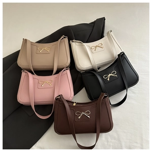 Detailed view of 5 stylish shoulder bags with chic golden metal bows and matte texture