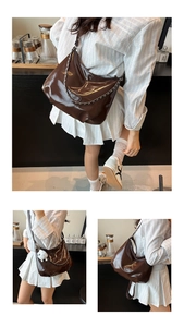 Detail of glossy chocolate brown leather shoulder bag with silver chain and plush charm