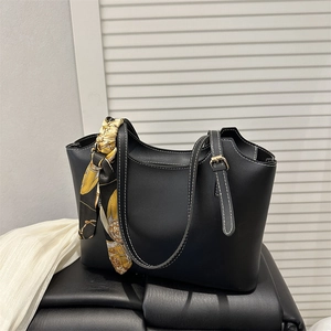 Black tote bag with white stitching and decorative silk scarf for professional women