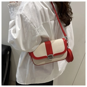 Detail of red and white crossbody bag with woven texture and mini round coin purse