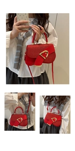 Detail of red glitter saddle bag featuring a bold gold buckle and detachable strap