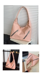 Detail view of pink lychee textured leather hobo bag featuring dual metal diagonal zippers
