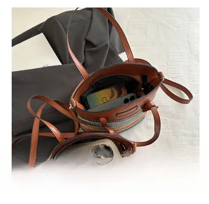 Detail showing internal capacity of the striped woven bucket bag with leather handles