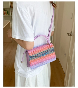 Detailed view of bohemian woven crossbody bag with colorful zigzag knit patterns