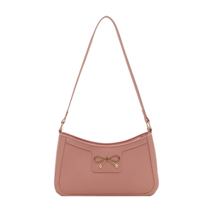 Elegant pink baguette shoulder bag featuring a decorative golden metal bow on the front