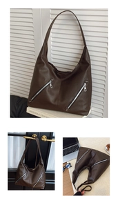 Close-up of brown litchi pattern leather tote bag with double silver metal zippers