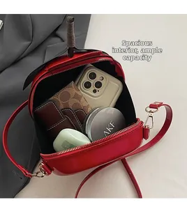 Détail montrant l'espace intérieur du petit sac à bandoulière rond rouge pastèque