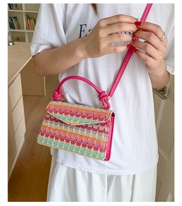 Detail of colorful rainbow woven crossbody bag with vibrant geometric knit patterns