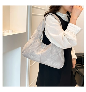 Grey vintage textured half-moon shoulder bag with geometric stitching and metal zipper