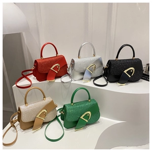 Detail view of five shiny small square bags with gold buckles in various trendy colors