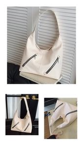 Close-up of beige tote bag featuring lychee texture faux leather and diagonal zippers