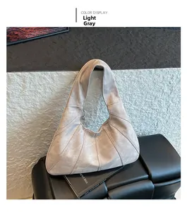 Detail of light grey geometric hobo bag with triangle stitching on matte finish