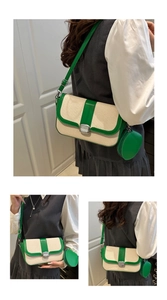 Detail of cream woven crossbody bag with green leather trim and small round coin purse