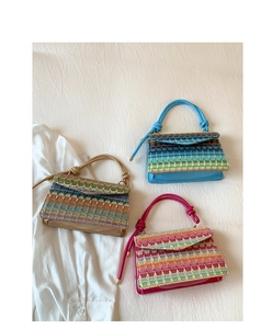 Three colorful woven handbags with knotted handles on a white fabric background