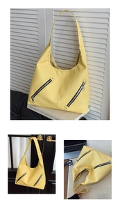 Detail of yellow pebbled leather hobo tote bag featuring stylish silver zipper accents