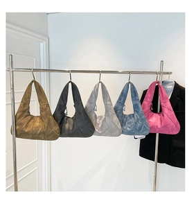Detail of multi-color croissant hobo bags with pleated texture and crescent design