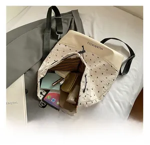 Top view of the interior capacity of a white pleated tote bag with geometric patterns