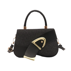 Minimalist black woven leather saddle bag with signature gold D-buckle and top handle