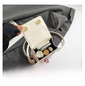 Top view showing the internal storage capacity of the white PU leather crossbody bag