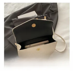 Interior view of off-white marble texture crossbody bag showing storage for phone and wallet