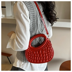 Stylish red round PU leather handbag with crocodile texture worn over the shoulder
