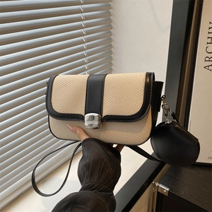 Modern color-block saddle bag featuring beige weave and black leather with coin purse