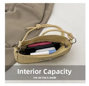 Top view of open beige woven bag showing interior space for phone, wallet and cosmetics