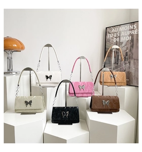 Fashionable shoulder bags in six colors with metallic butterfly charms and pleated texture
