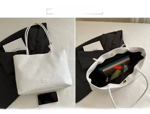 Detail of the woven texture tote bag interior featuring the main compartment with magnetic buckle