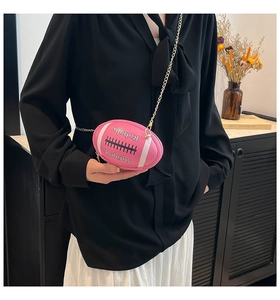 Detail view of a pink rugby-shaped mini chain bag with embossed letters and white stripes
