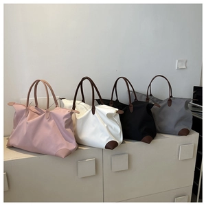 Bolsos de viaje de nailon de gran capacidad en cuatro colores en un armario