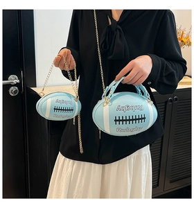 Macro detail of sky blue rugby-shaped crossbody bags in two sizes with gold chain straps