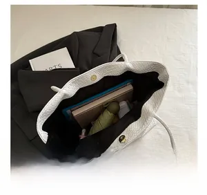 Internal view of white tote bag showing large capacity and magnetic metal closure