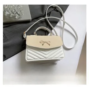 Detailed size comparison of a beige woven mini crossbody bag with a smartphone