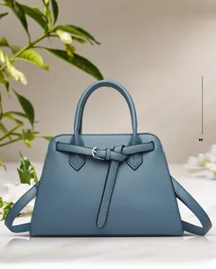 Detailed view of blue litchi grain leather tote bag with metal buckle and top handle