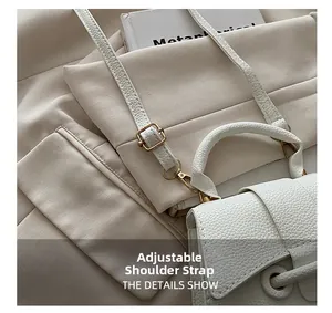 Detailed shot of white lychee leather texture and golden adjustable buckle on the strap