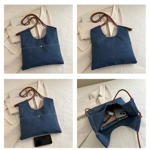 Detail view of denim tote bag showing brown rope strap and spacious internal capacity