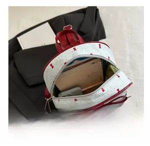 Interior view showing large capacity of the red and white polka dot mini backpack