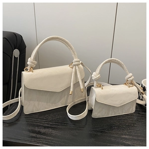 Detail of white envelope handbags in two sizes with marble texture and gold hardware