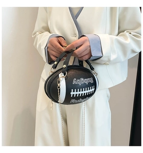 Detail of creative rugby ball shaped crossbody bag with gold chain and letter embossing