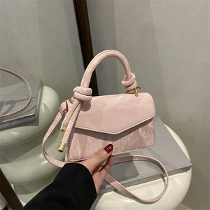 Pink minimalist handbag with marbled texture, top knot handle and adjustable strap