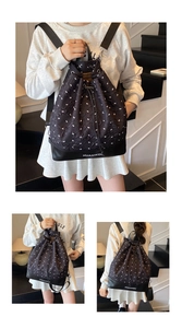 Detailed views of a black bucket bag with white bow patterns and drawstring closure
