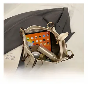 Detail view of large tote bag interior showing capacity for tablet and cosmetics