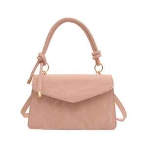 Pink wrinkled leather crossbody handbag with gold hardware and knotted handle design