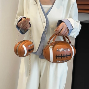 Rugby shaped brown leather crossbody bag with chain strap and matching small coin purse