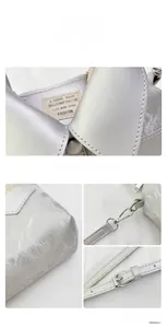 Silver metallic leather texture detail with interior label and sturdy metal hardware