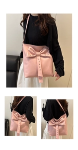 Close-up of pink PU leather bag with large bow and silver stud details on strap