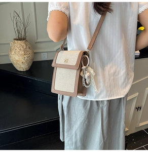 Canvas mini crossbody bag with gold logo, pearl charm and adjustable shoulder strap