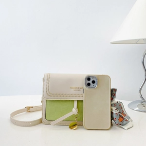 Detail view of two-tone cream and lime green crossbody bag compared to a smartphone